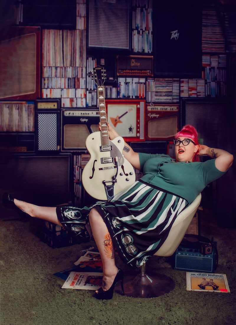 Jane Rose sat in chair with guitar